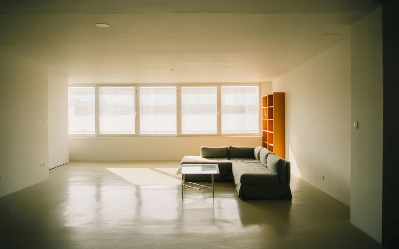 small living room with open layout, minimal furniture, airy apartment interior, natural light