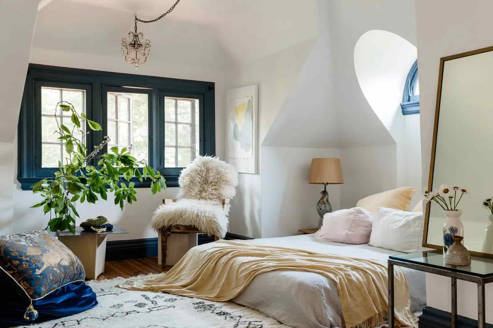 “Cozy bedroom with layered bedding, plush rug, warm lighting, neutral walls, indoor plants, Pinterest-style photography”